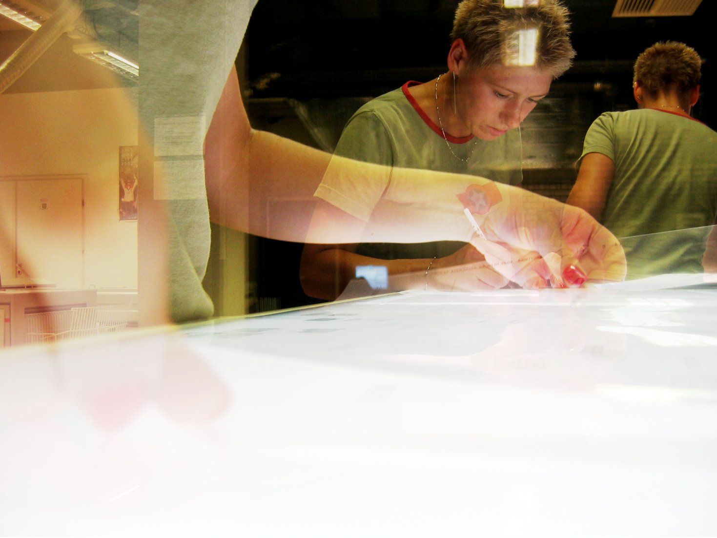 a young man who is working on soing with a pair of scissors