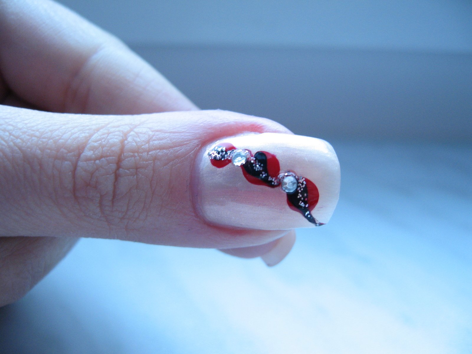 nail art that includes the colors of hearts and skulls