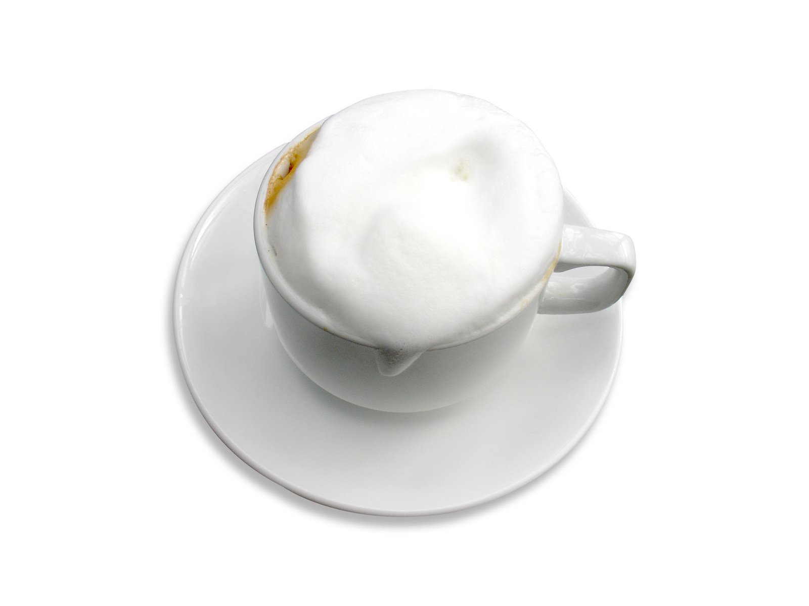 a cappuccino with cream on top is sitting in a white saucer