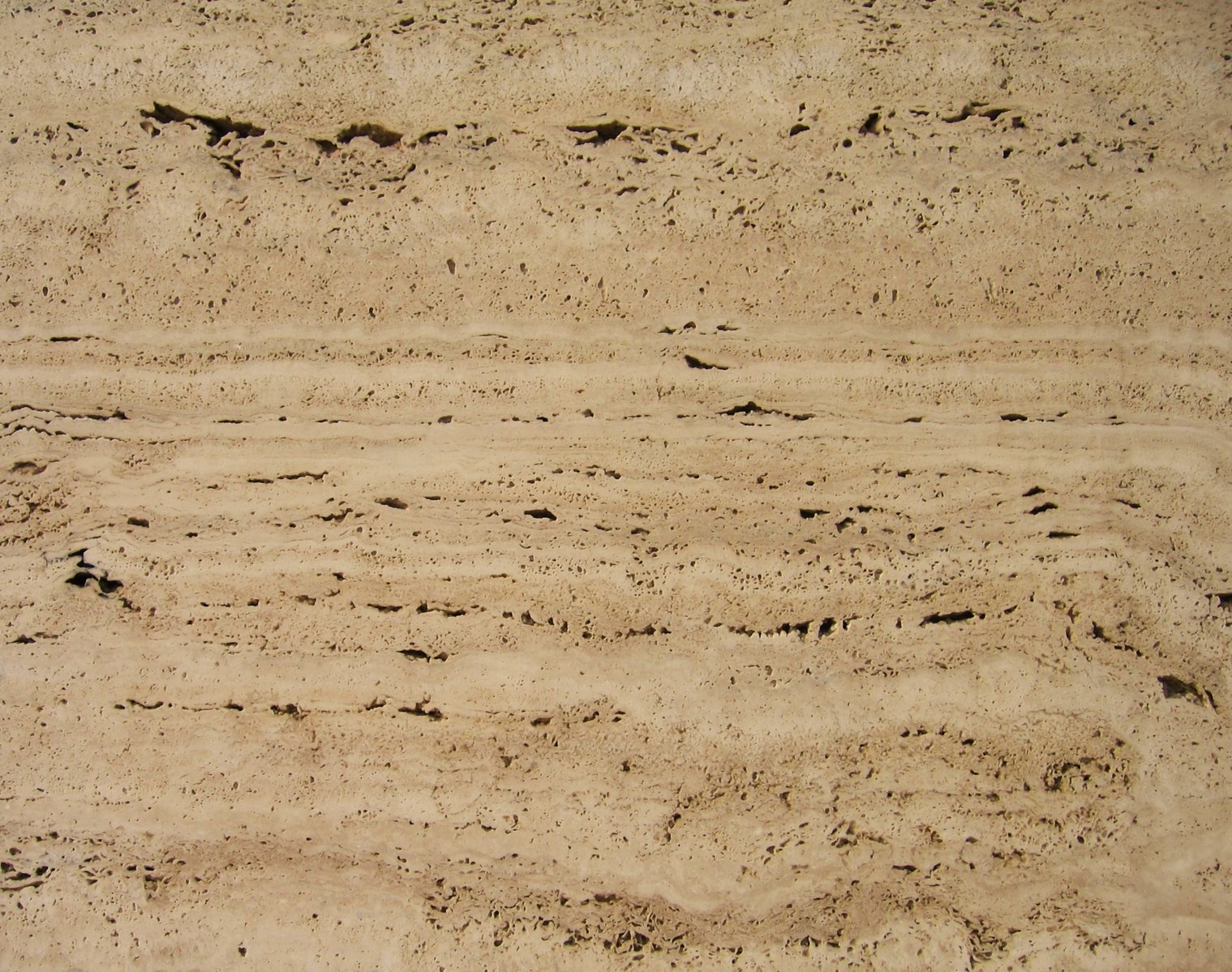 the view of an area with sand and footprints