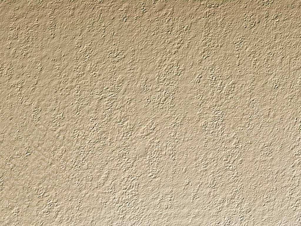 a corner of a stucco wall with no vegetation in it