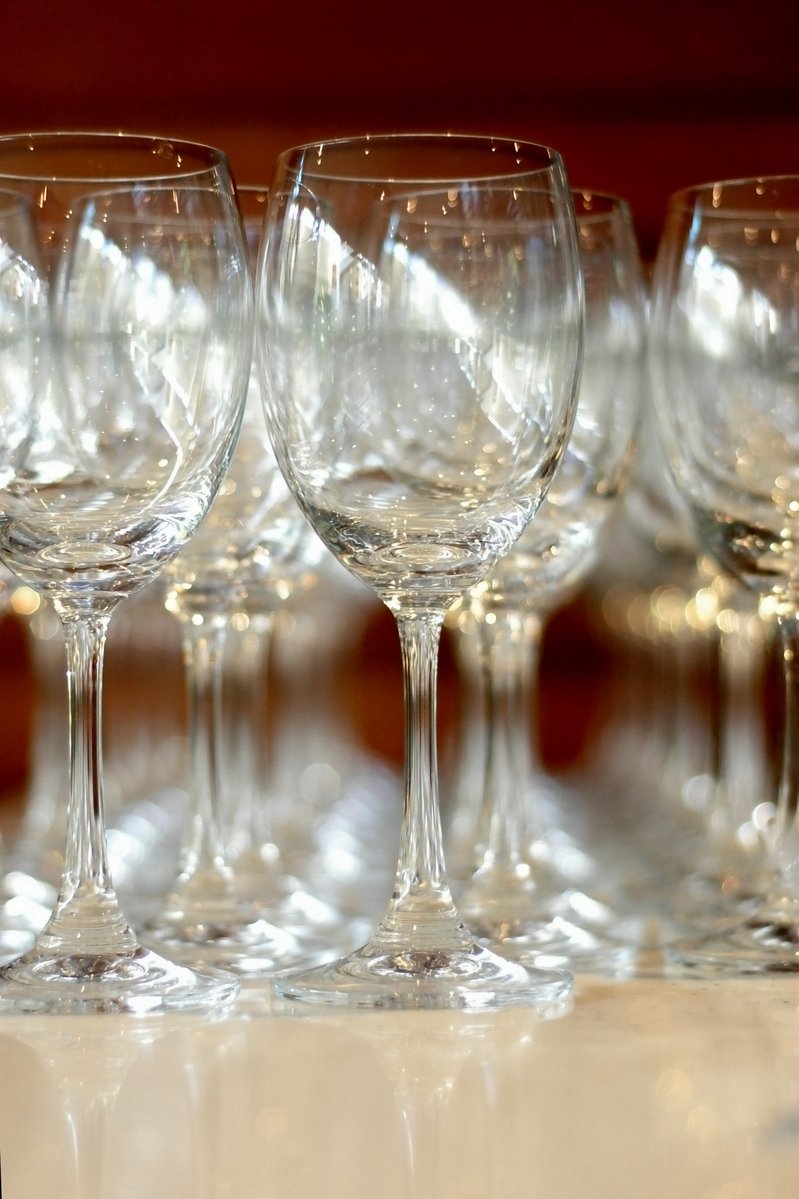 several glasses are lined up in a row