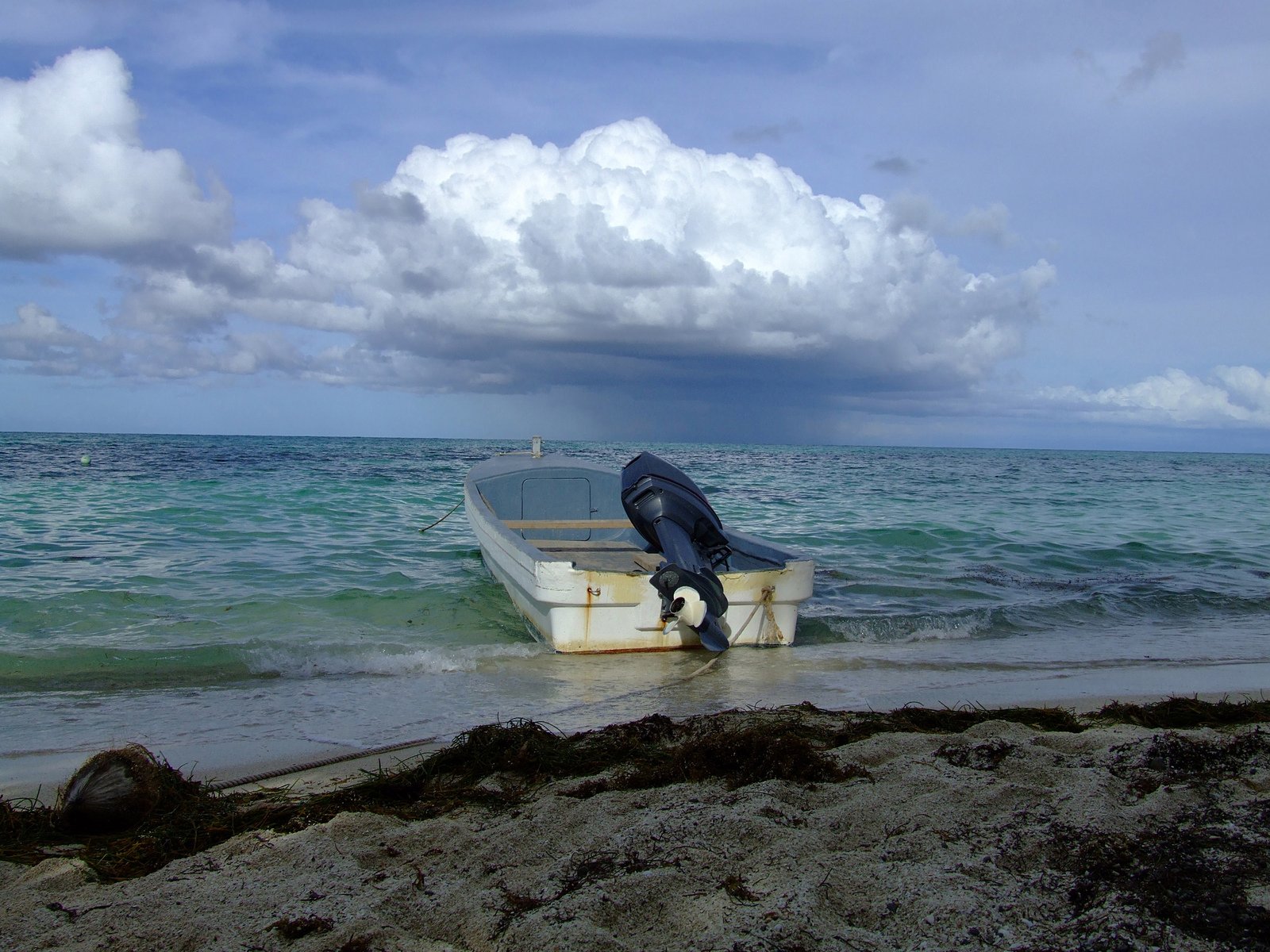 a man is getting into a boat at the ocean