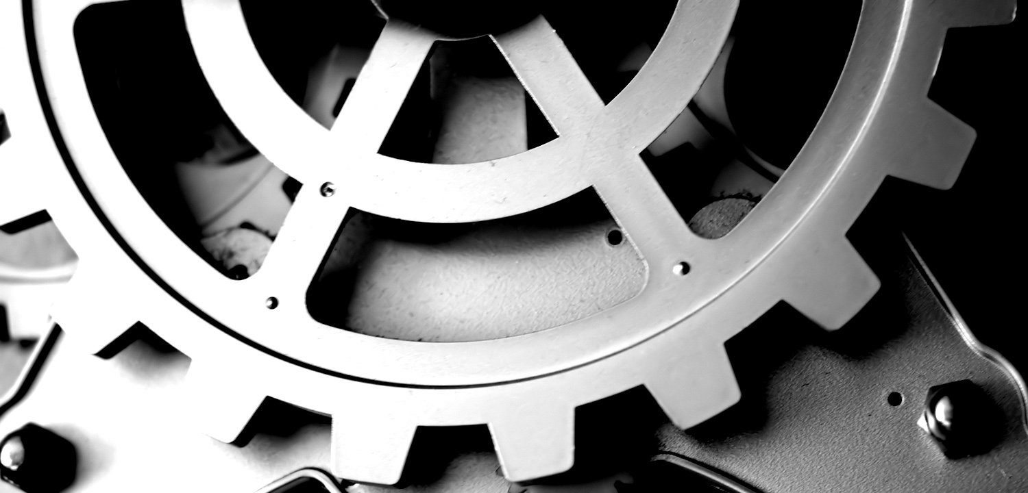 gears and wheels with spokes on a black surface