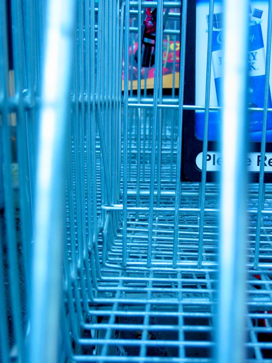 blue shopping carts sitting in an empty shopping center