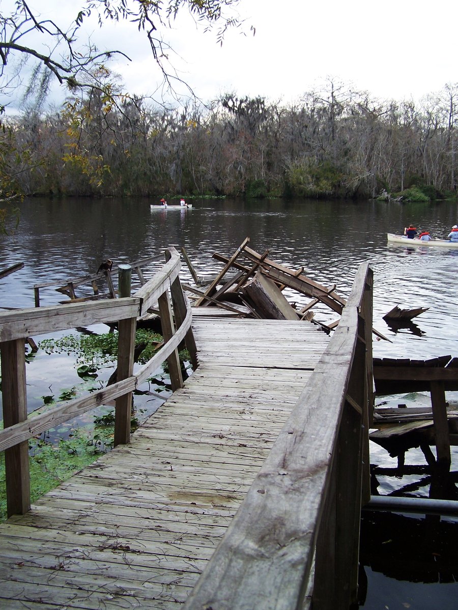 a wooden dock that is laying across a river