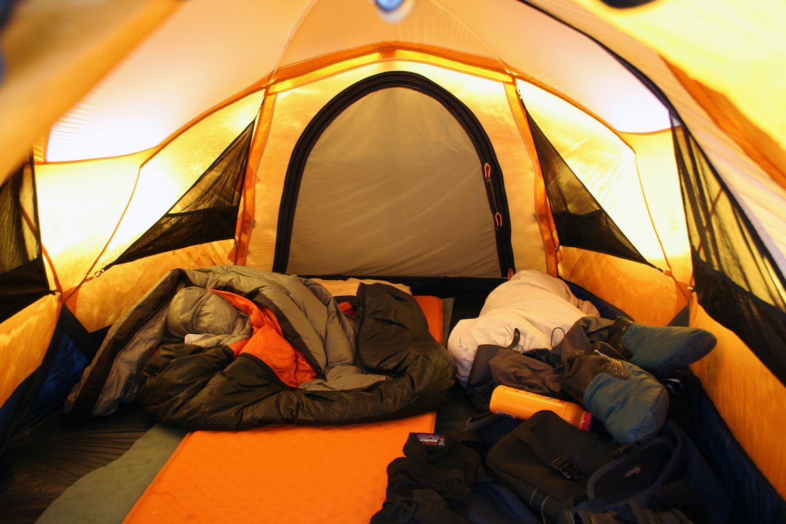 a tent with clothes set up inside the doorway