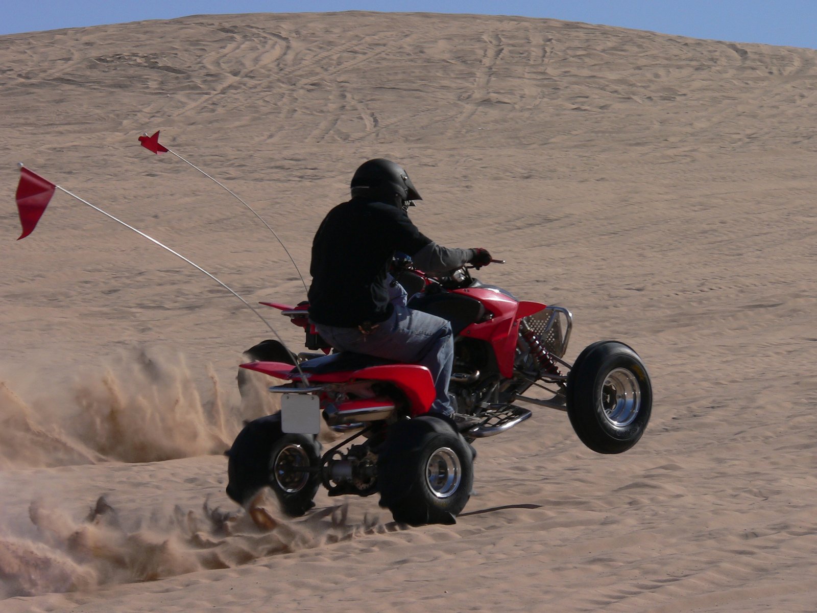 a person is riding an atv in the sand