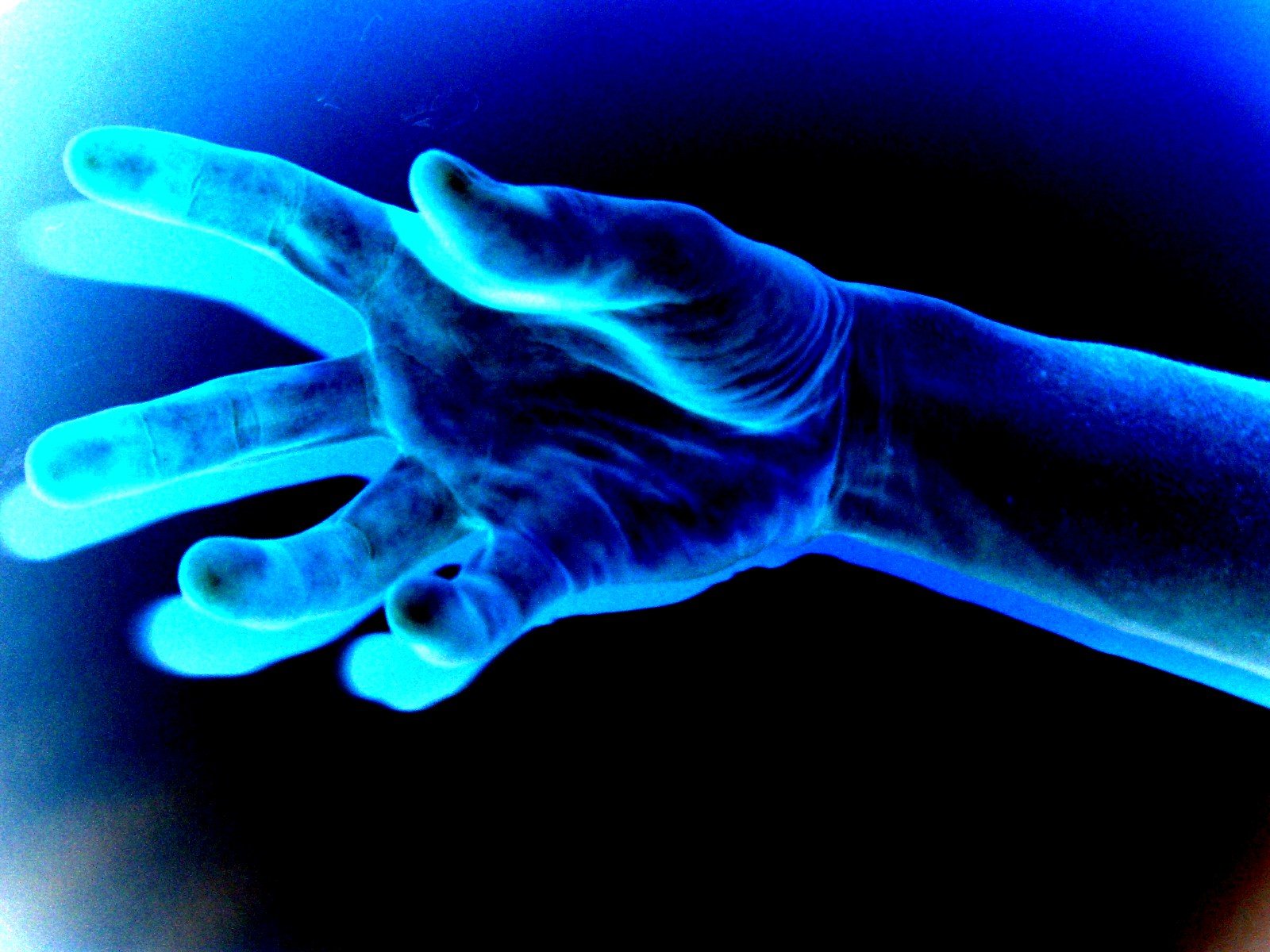 a hand reaching up towards soing blue and green