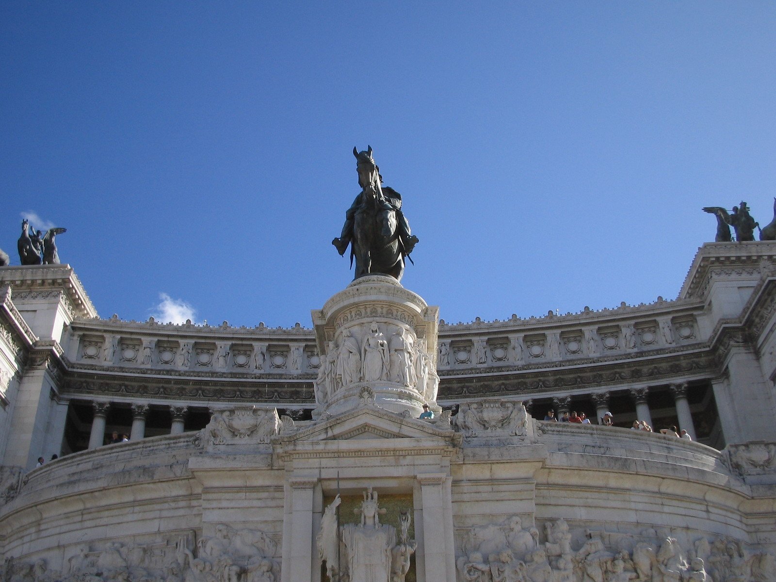 statue at the base of an elaborate stone building