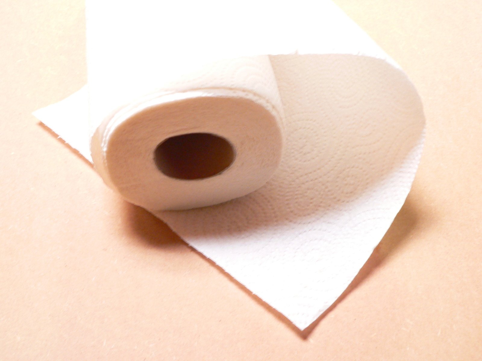 two rolls of white paper sitting on top of each other