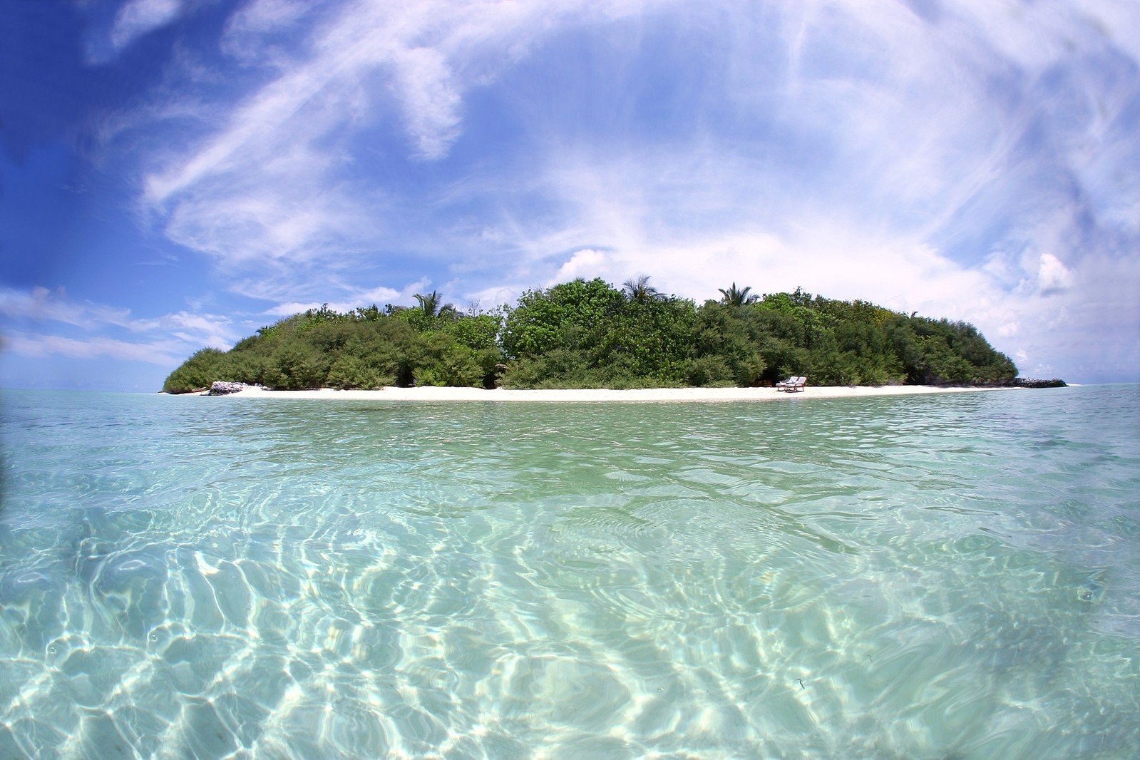 an island with a beach surrounded by water