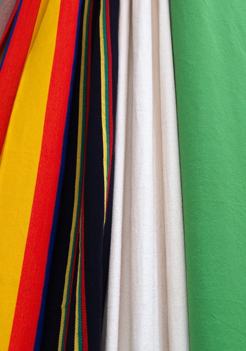 rainbow colored striped sheets piled on top of each other