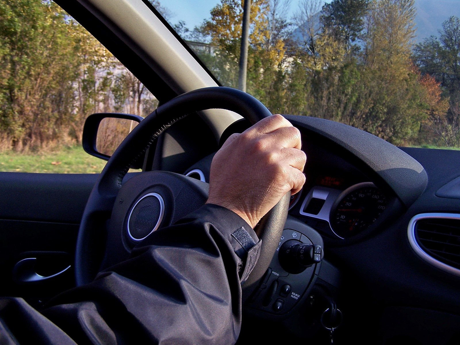 the driver is driving and he is listening to music