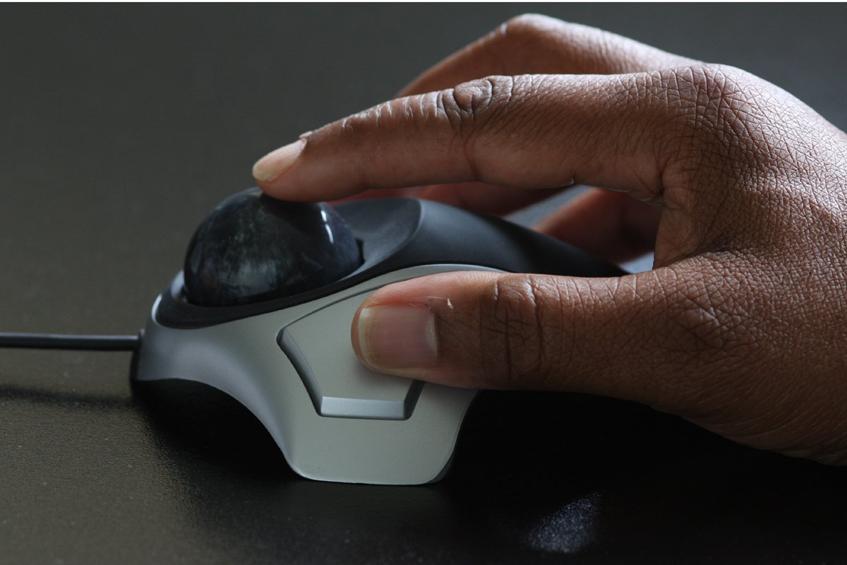 a person is holding the mouse and pressing the on