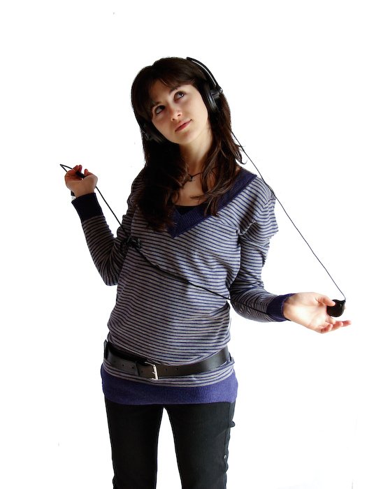 a woman is standing up with headphones on