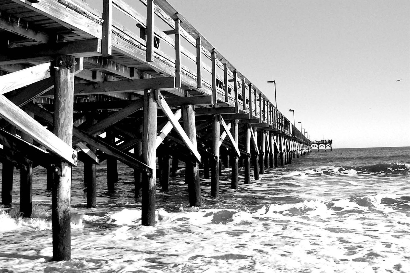 a large pier stretching into the distance of the ocean