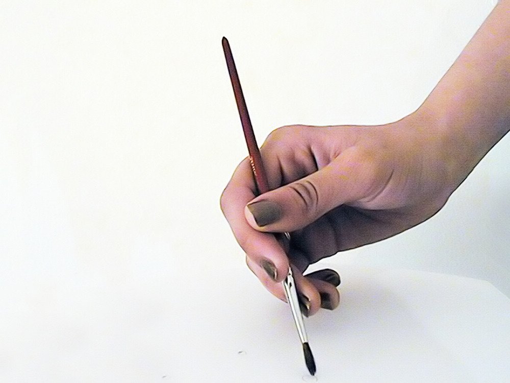 a hand is holding a small pencil with two black and white tips