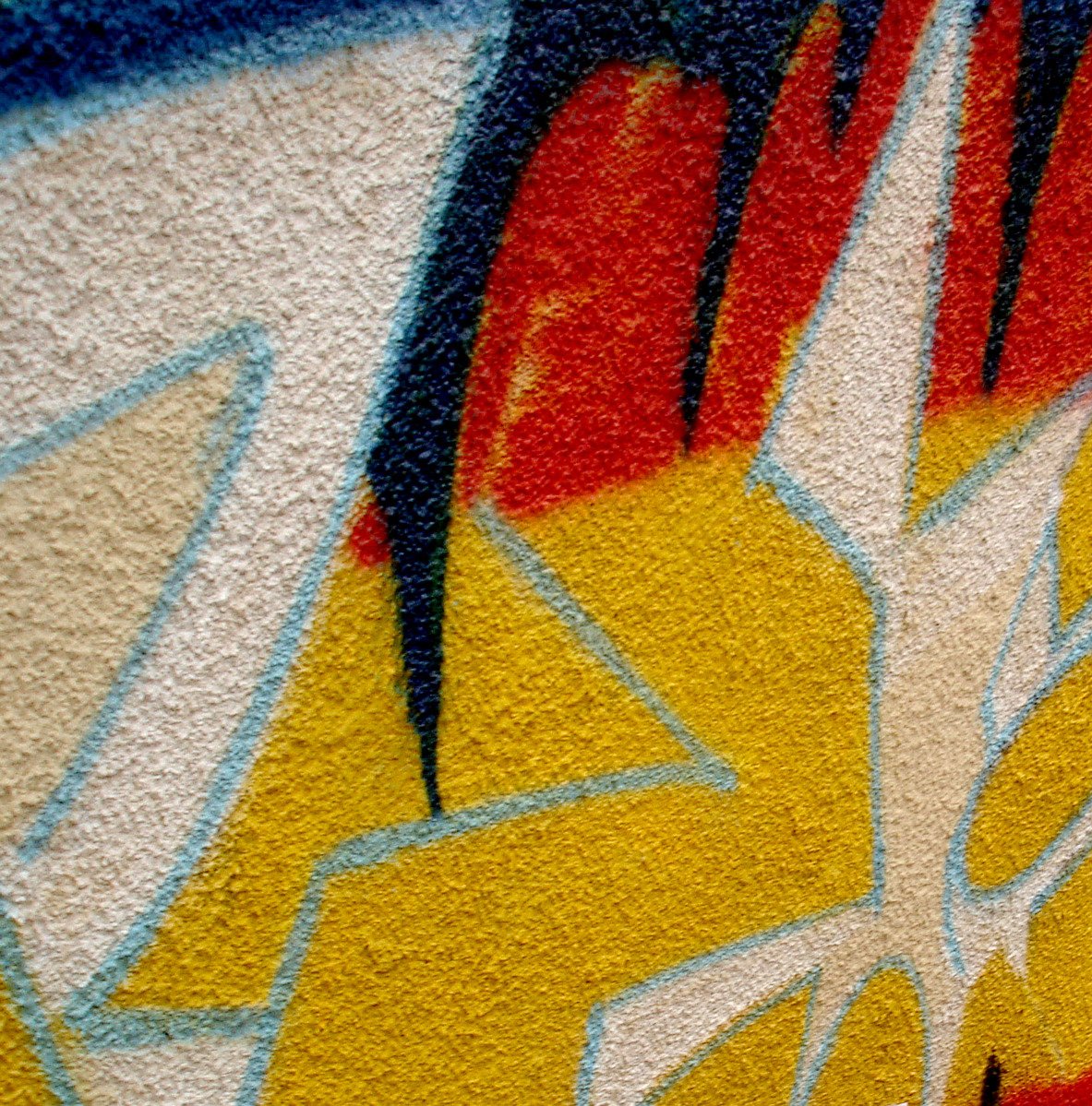 colorful graffiti painting on a wall with yellow, blue, and red
