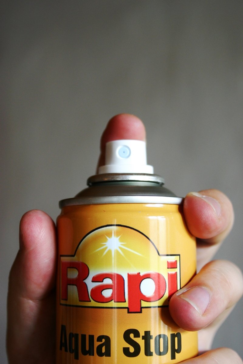 a person holding a yellow spray can with the words rapid on it