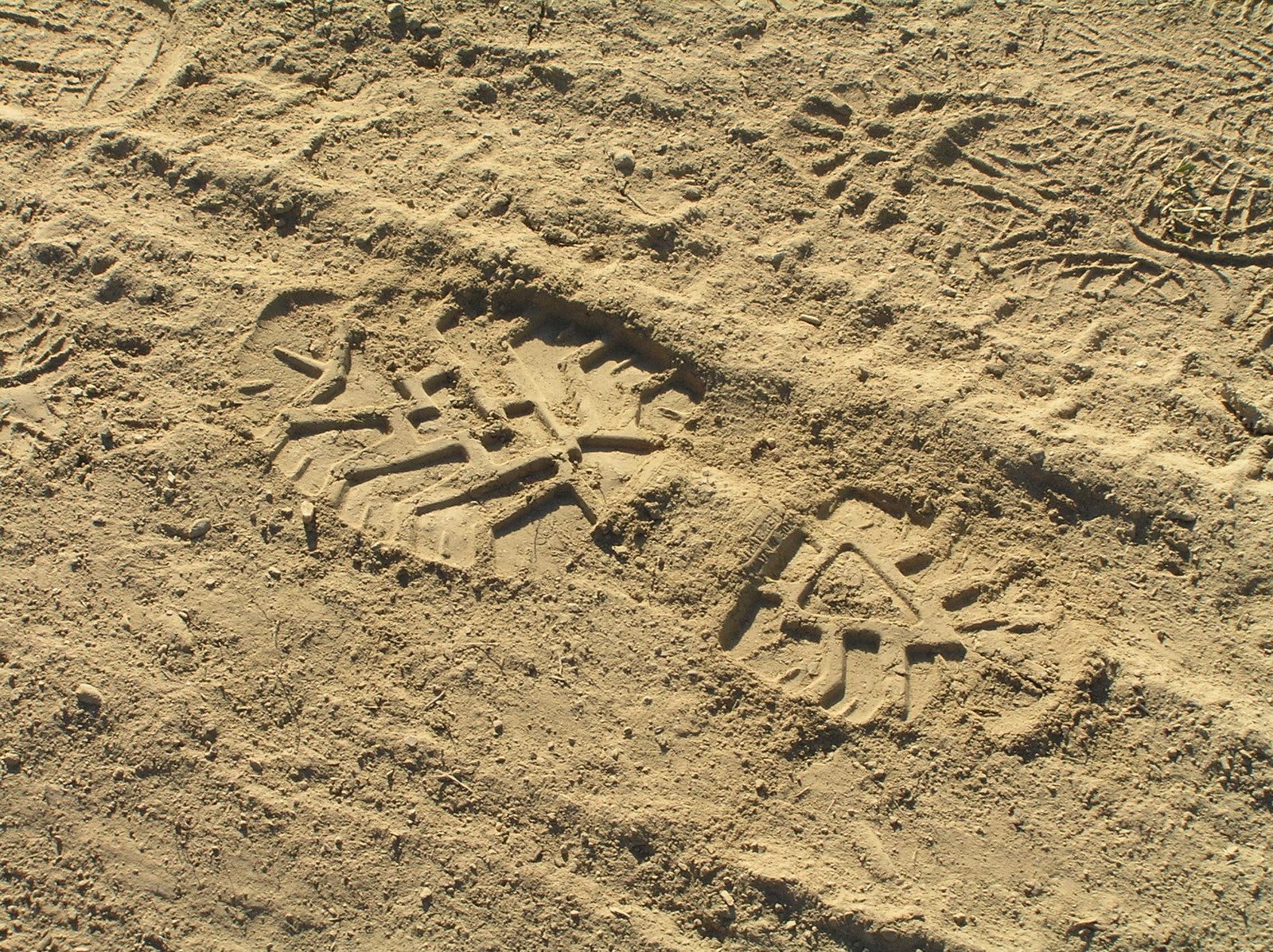 a person with an umbrella on a dirt ground