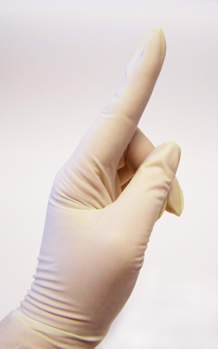 a gloved hand with an extended thumb points