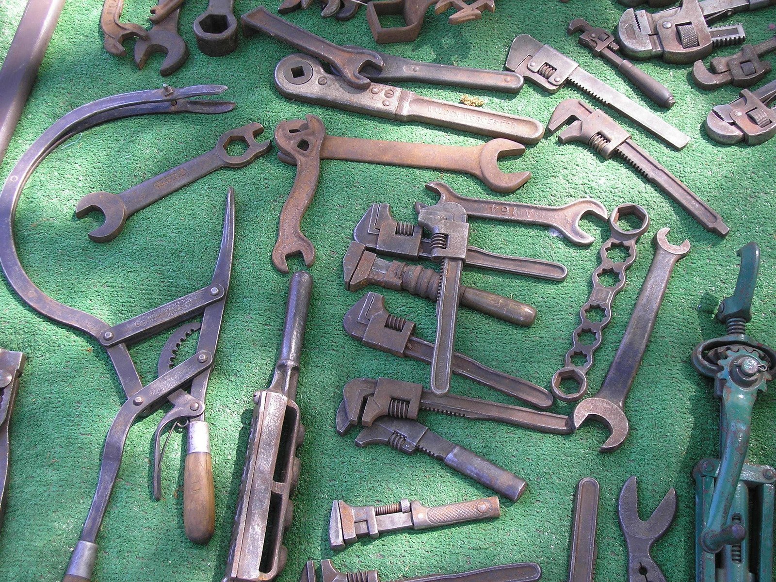 a pile of spanner wrench heads and tools