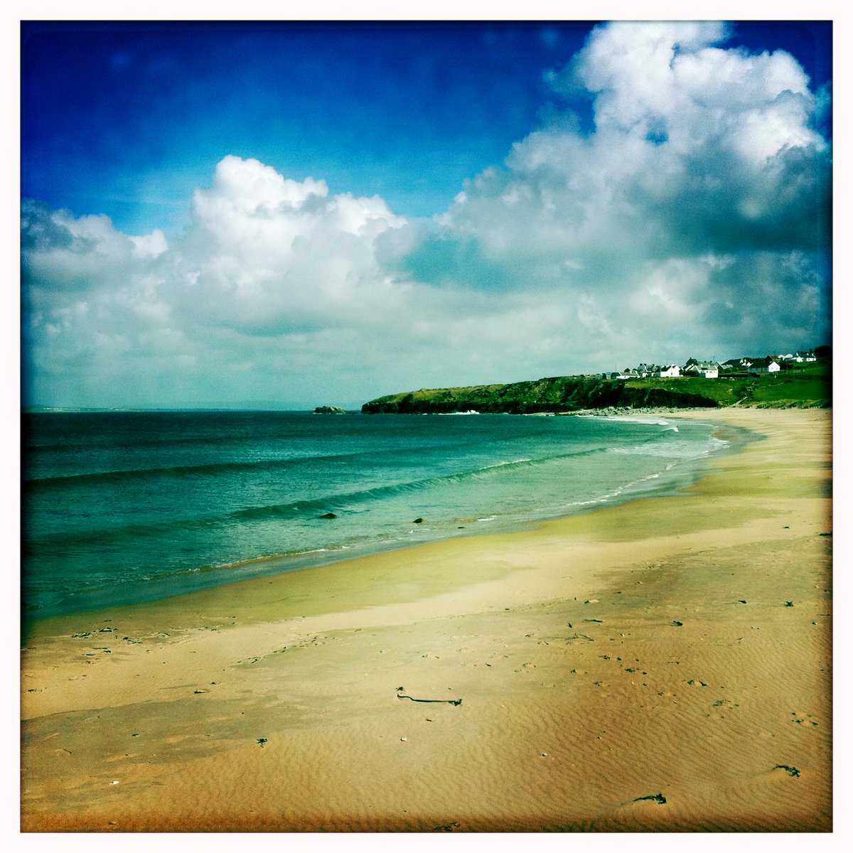 a wide, sandy beach on a clear day