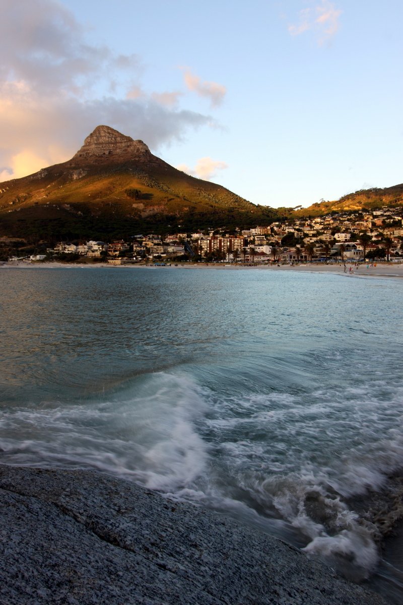 the waves are rolling in front of a town