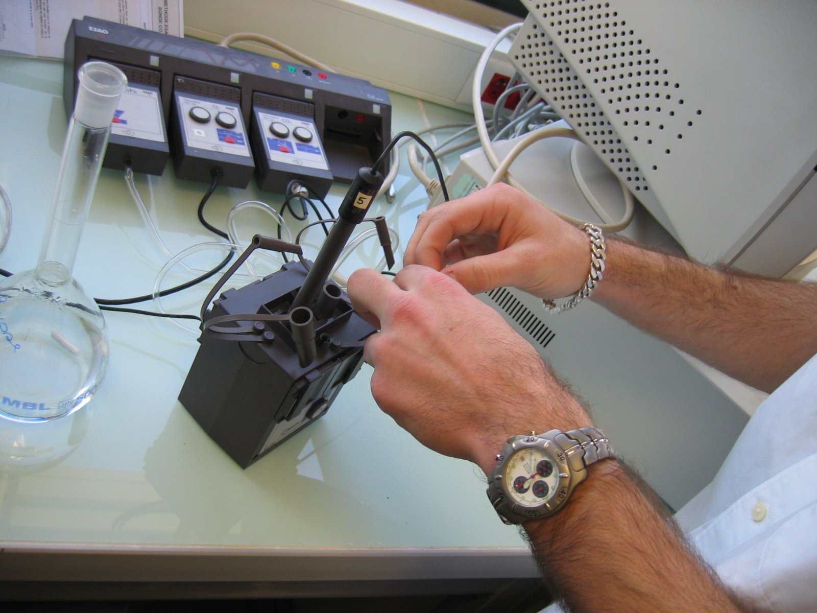 the person is working on his robot while on the phone