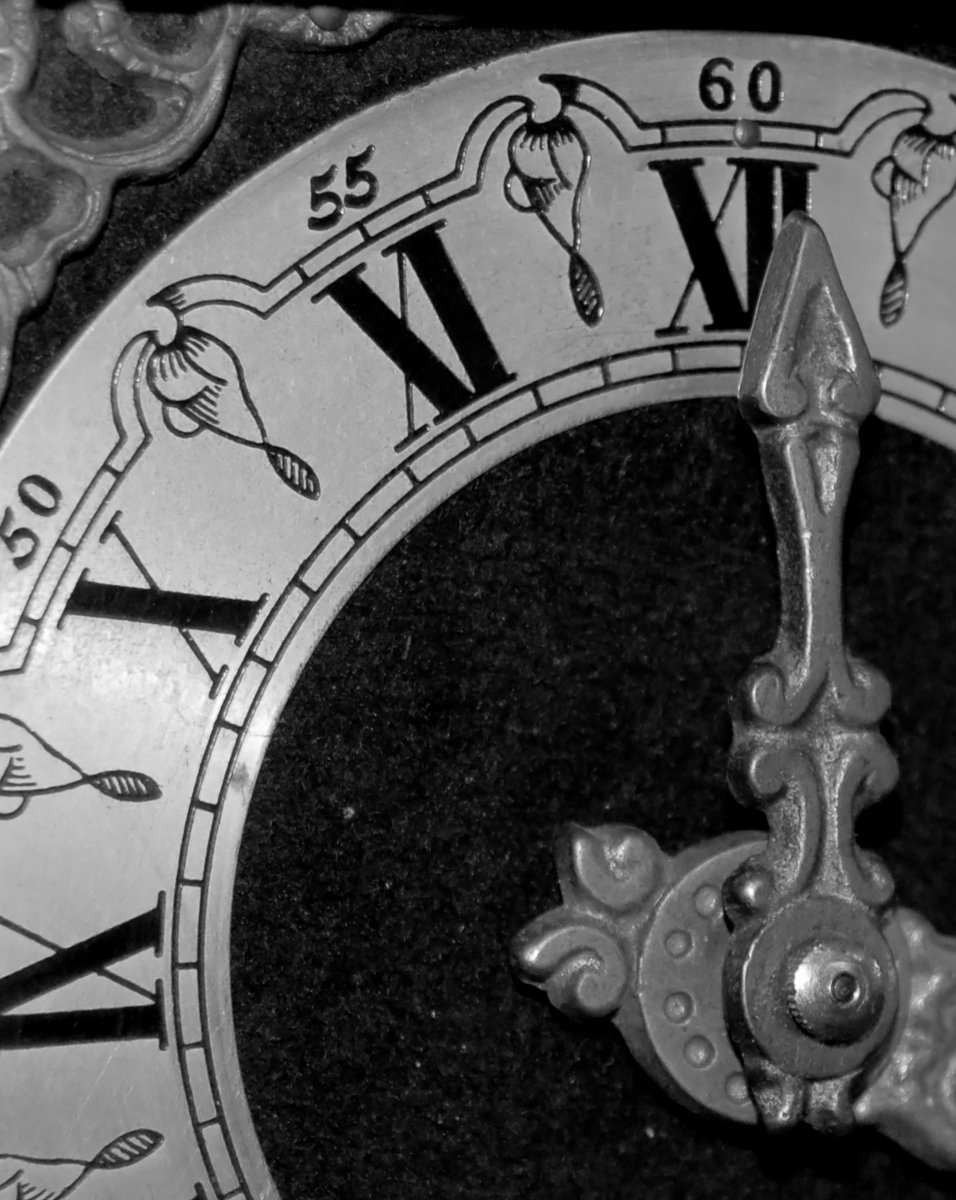 a close up of a clock face with the time displayed