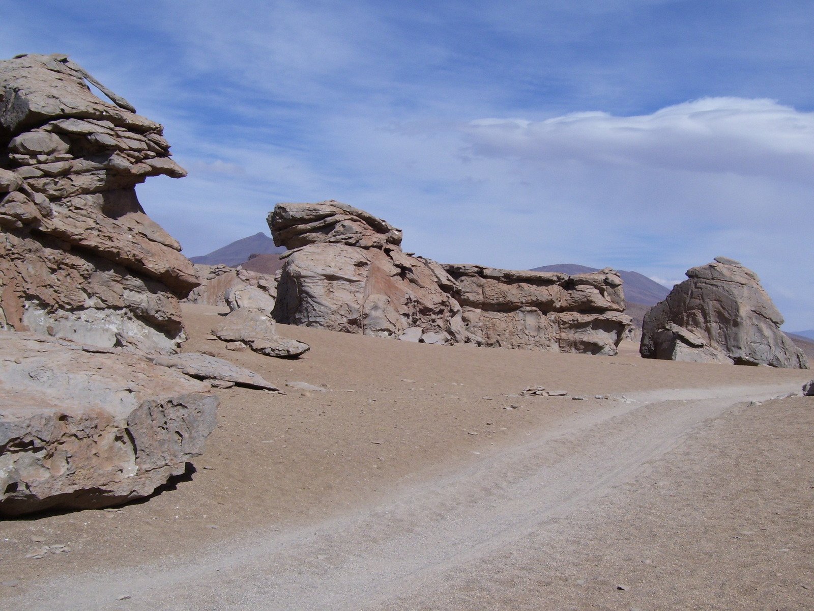 dirt road and rocks with blue sky in the background