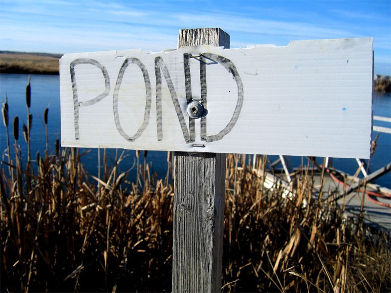 a wooden post that has a sign on it