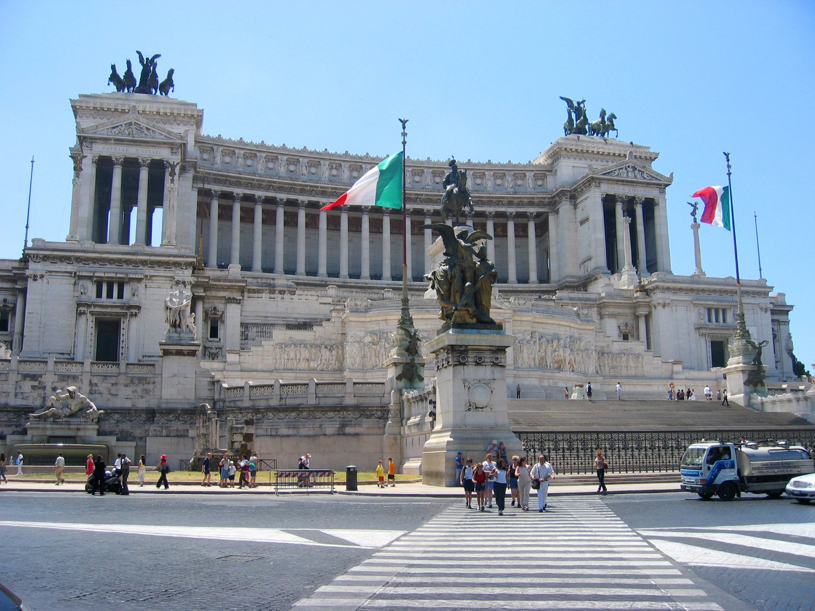 a tall building with an italian flag and columns