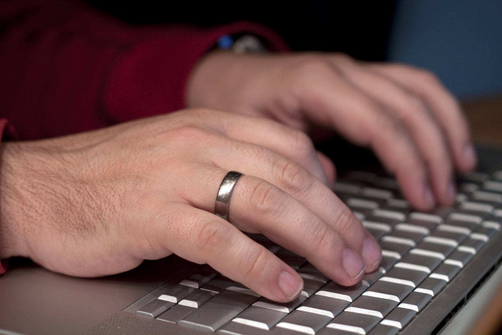 a person typing on top of a laptop