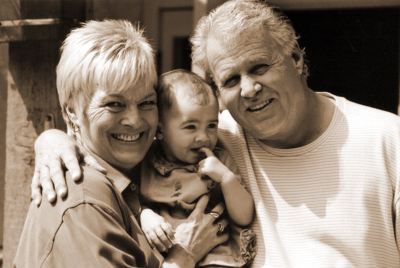 an older couple and a younger woman are smiling