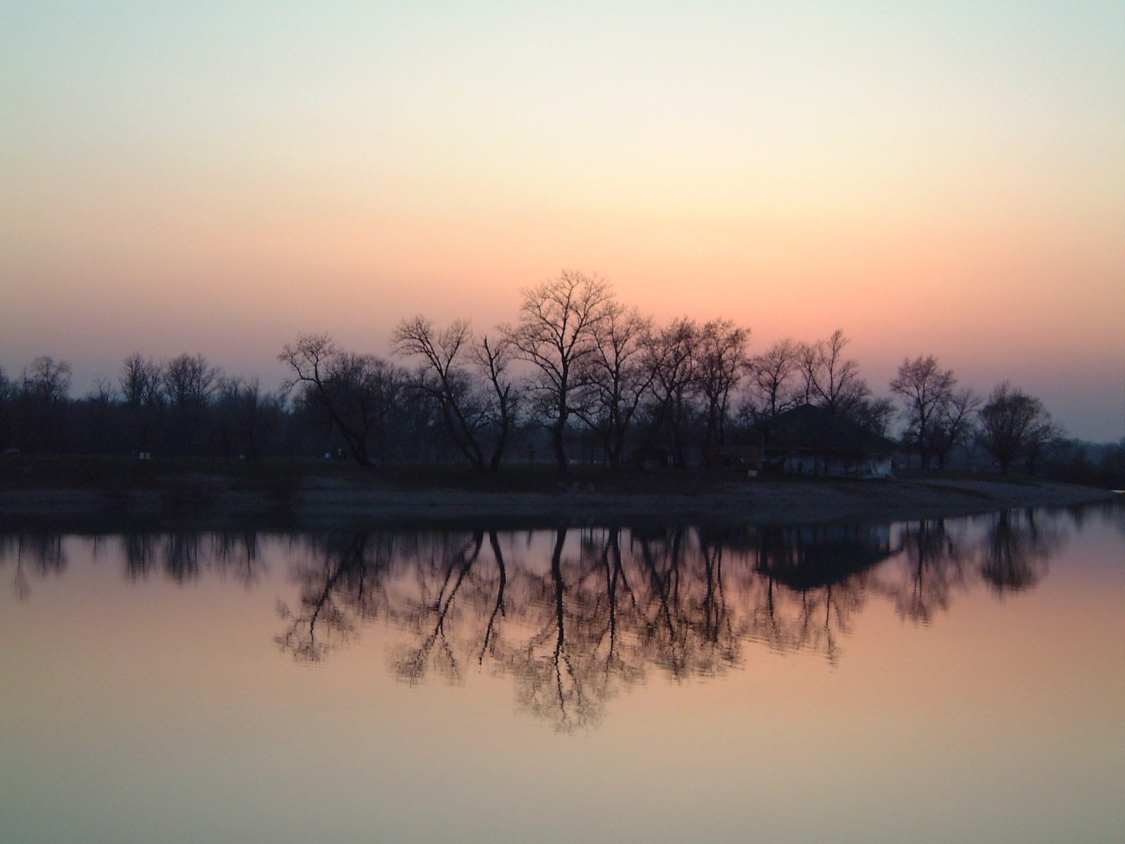 a lake at sunset is reflected in the water
