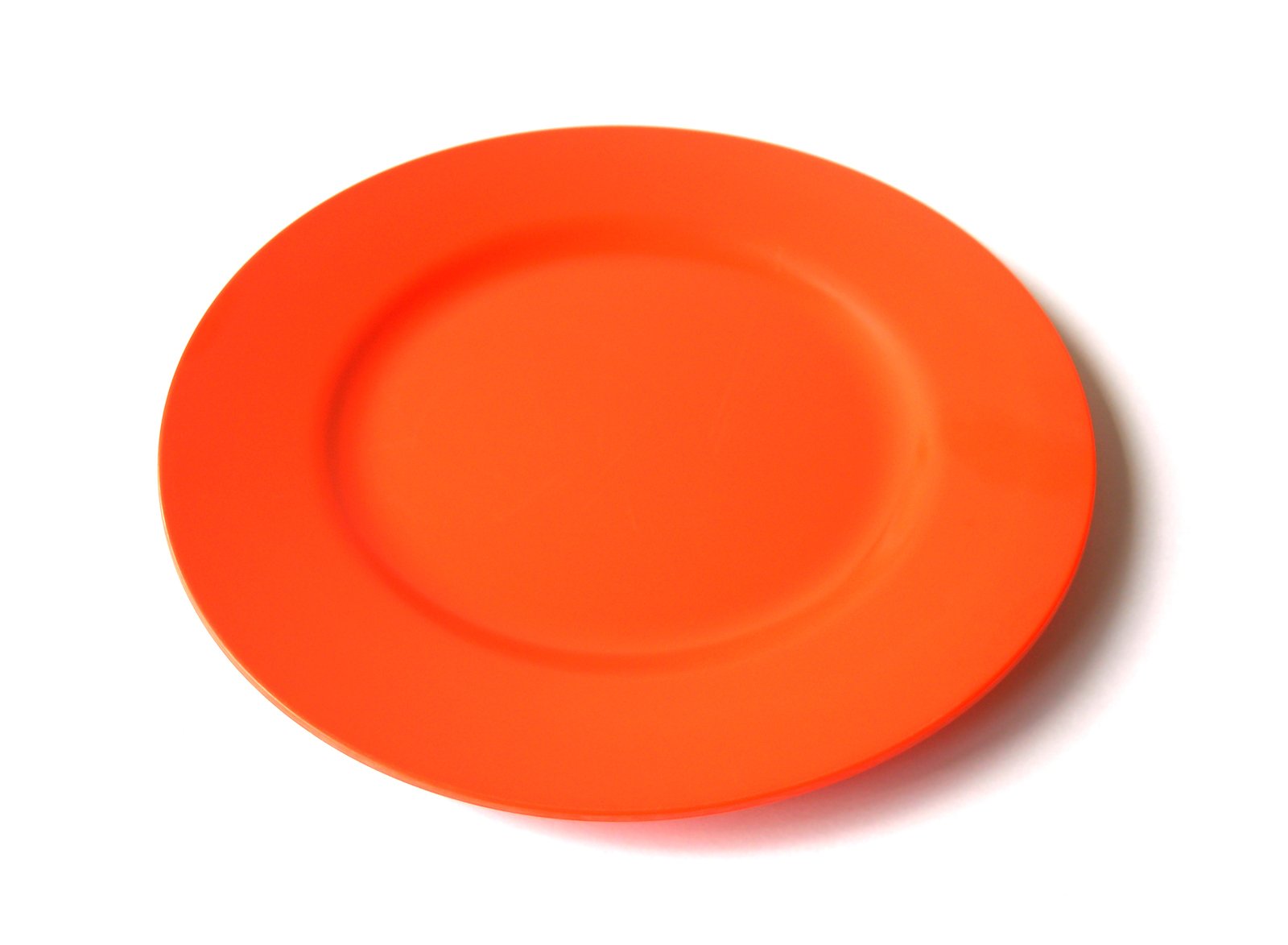 an orange plastic plate sitting on top of a table