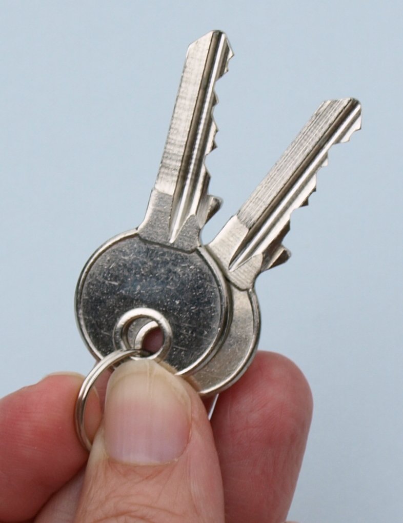 an old silver key is attached to a key ring