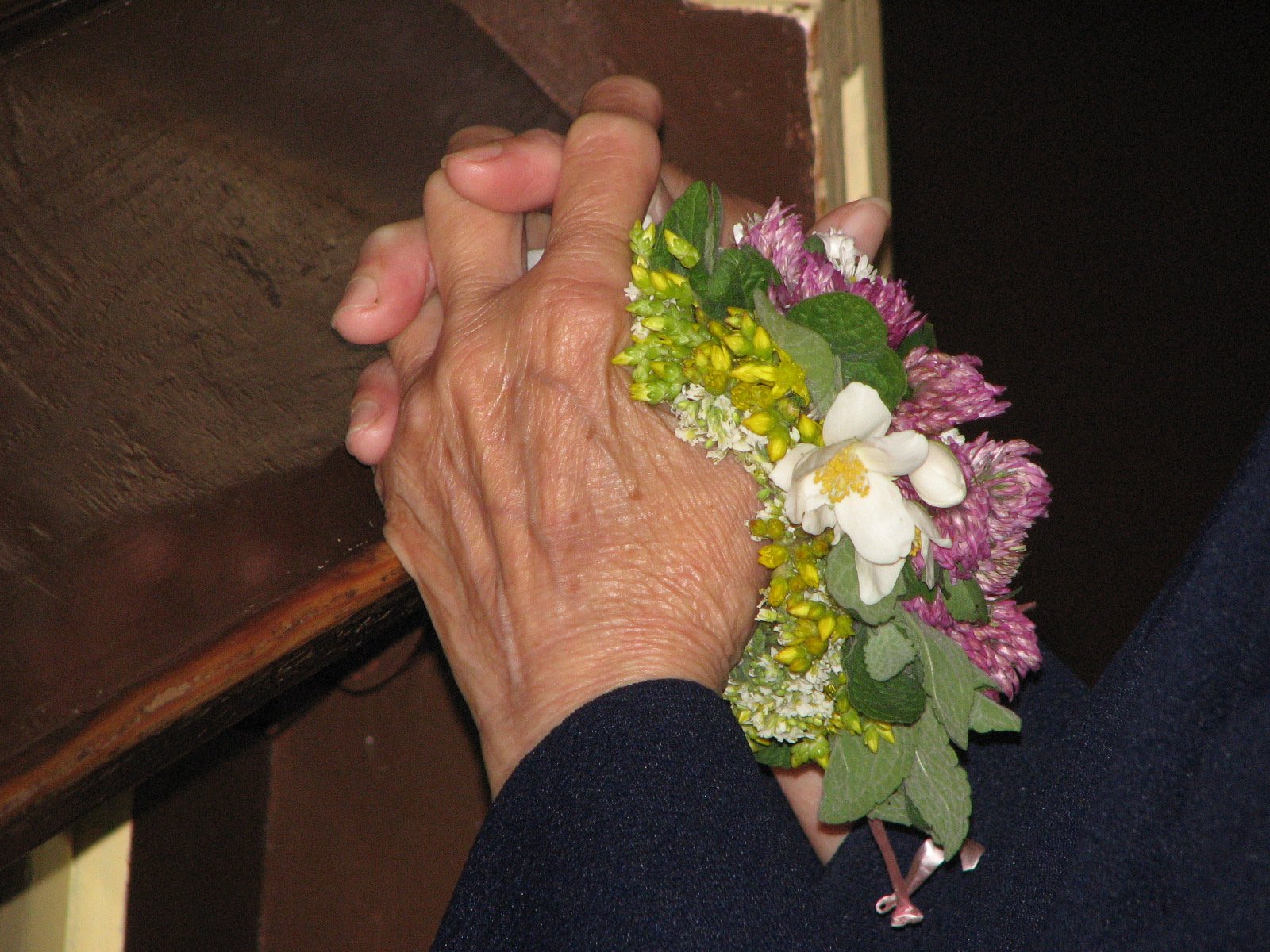 a person holding flowers and placing them in their palm