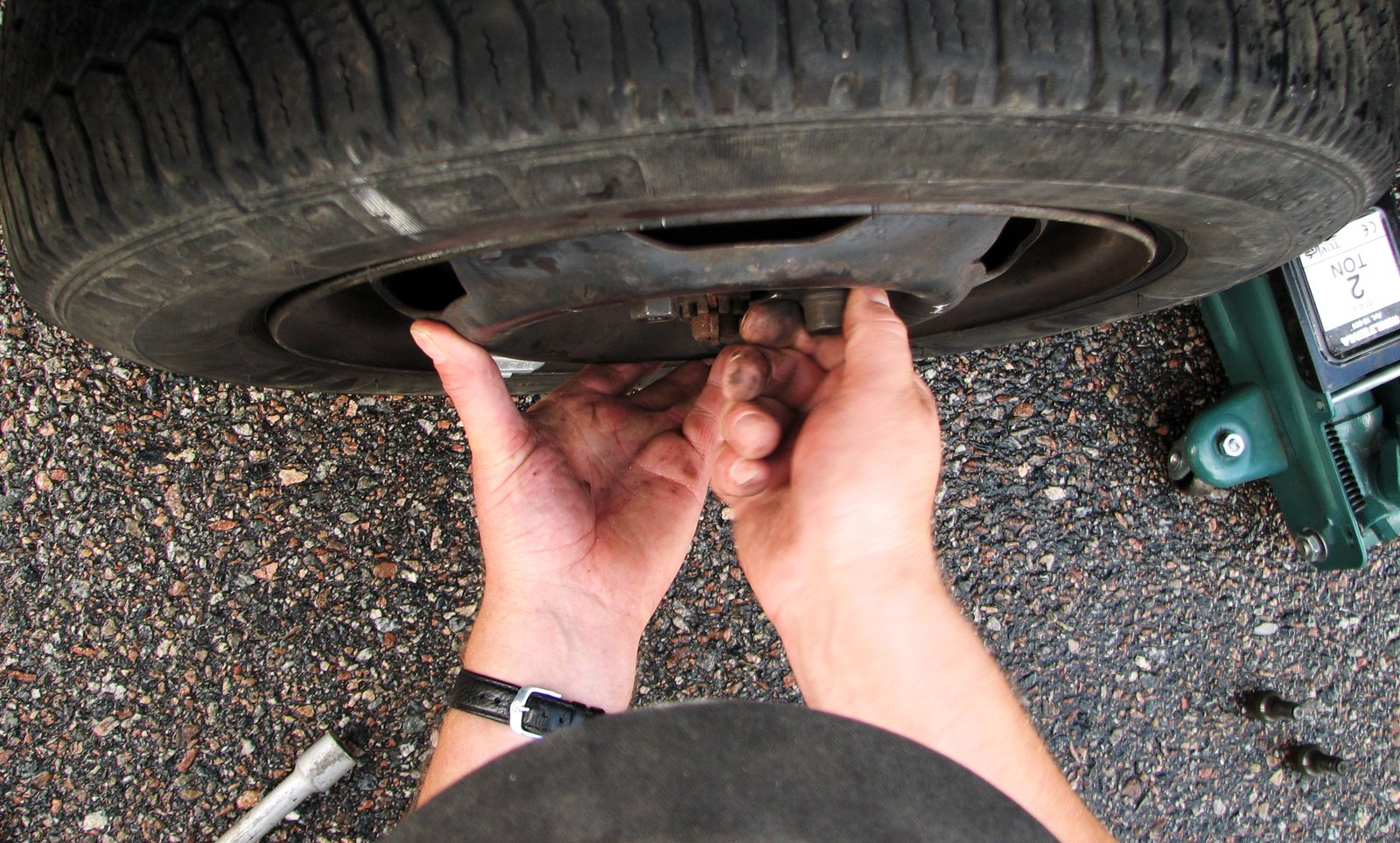 the view of hands working on the tire rim