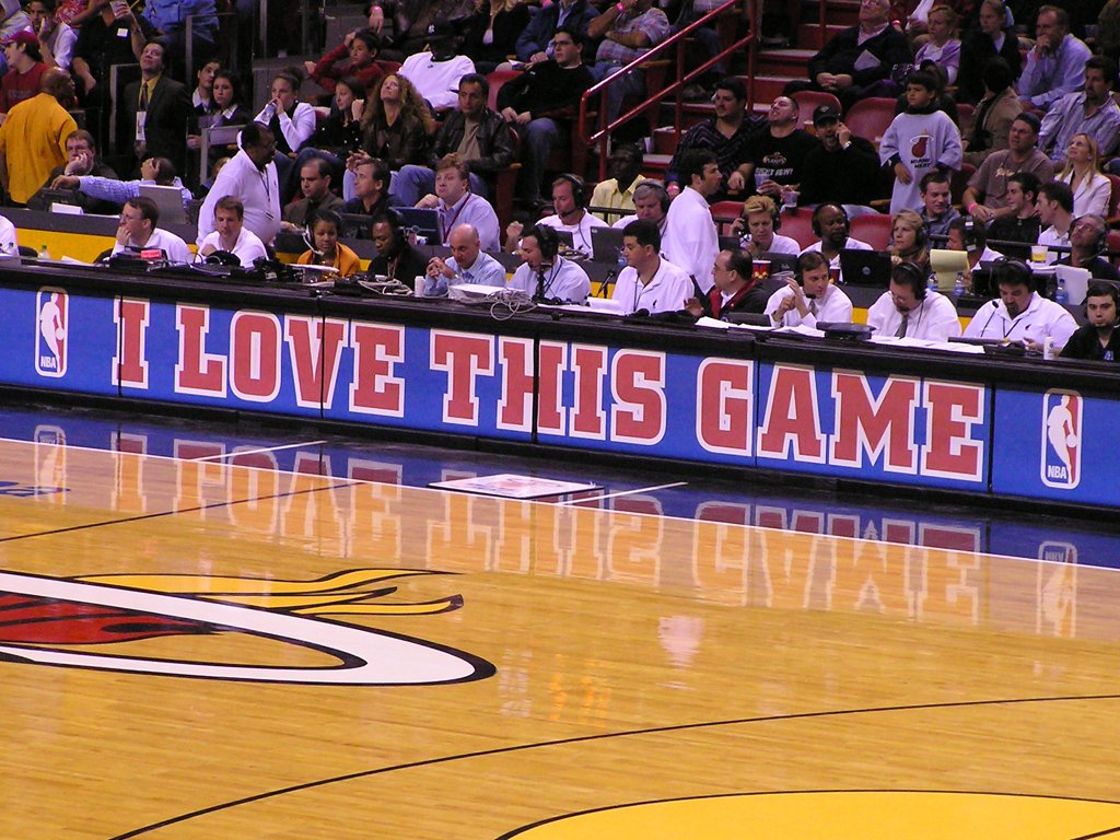 a basketball court that has fans sitting in the stands