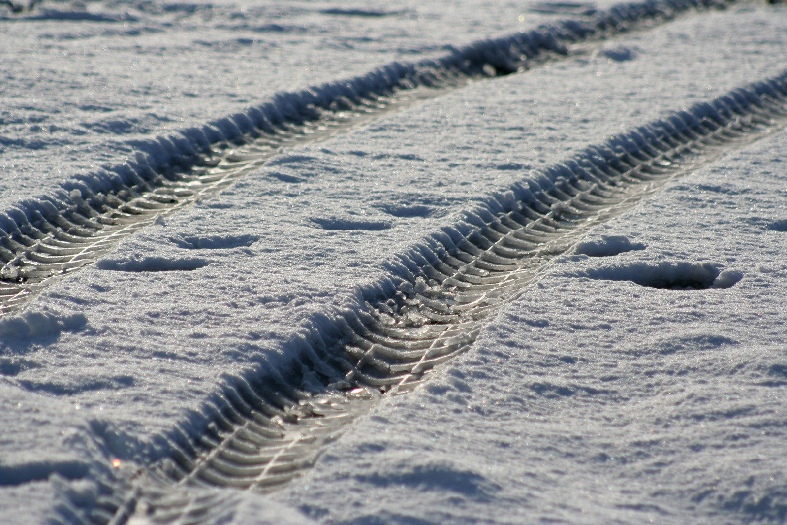 snow tires lay on the ground in the daytime