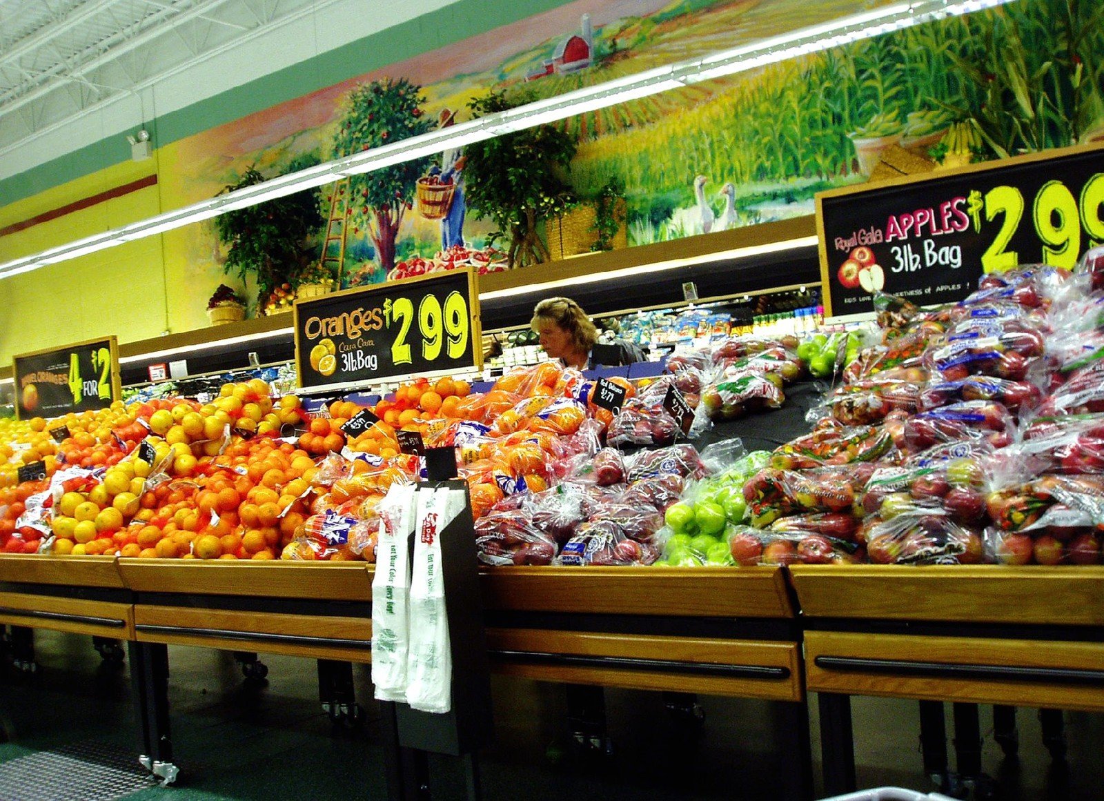 an indoor market with produce for sale in large areas