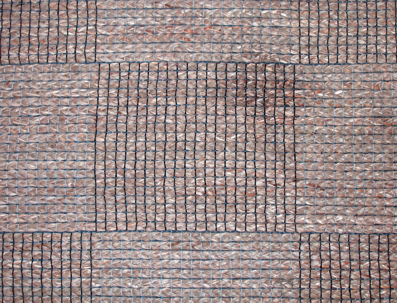 textured brick and stone tile wall with mesh covering