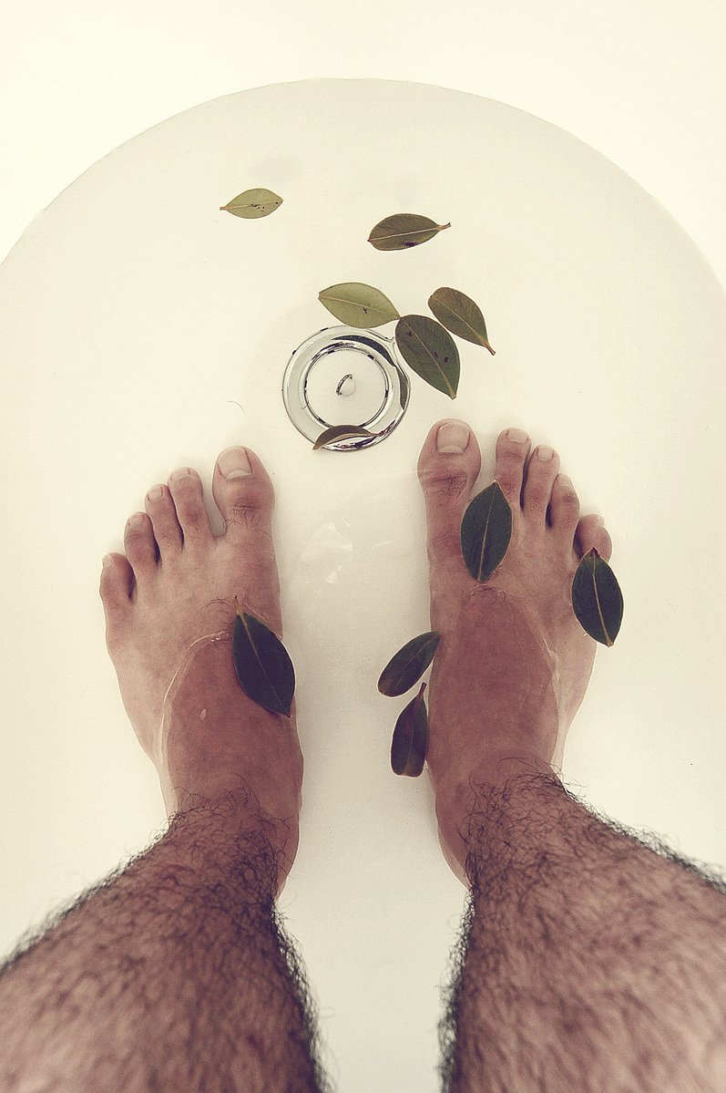 an image of a person's legs standing on top of the bathroom