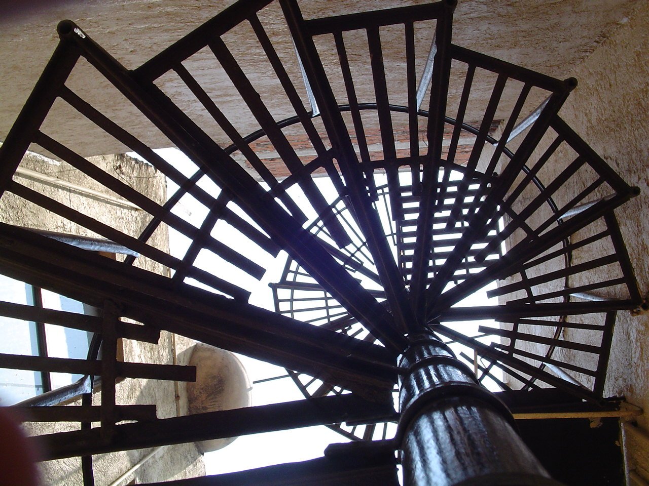 a circular metal piece sitting on the ground