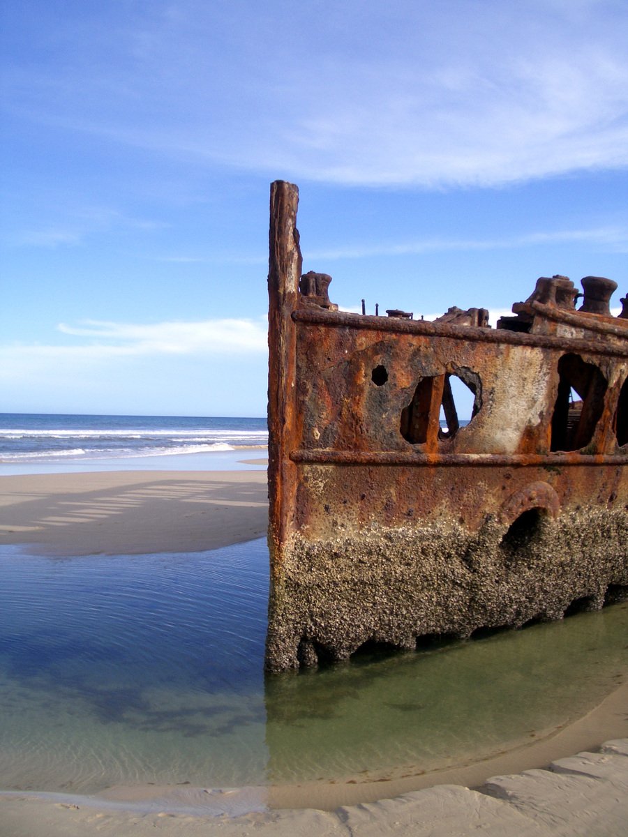 rusted ship remains are lying in the sand at the beach