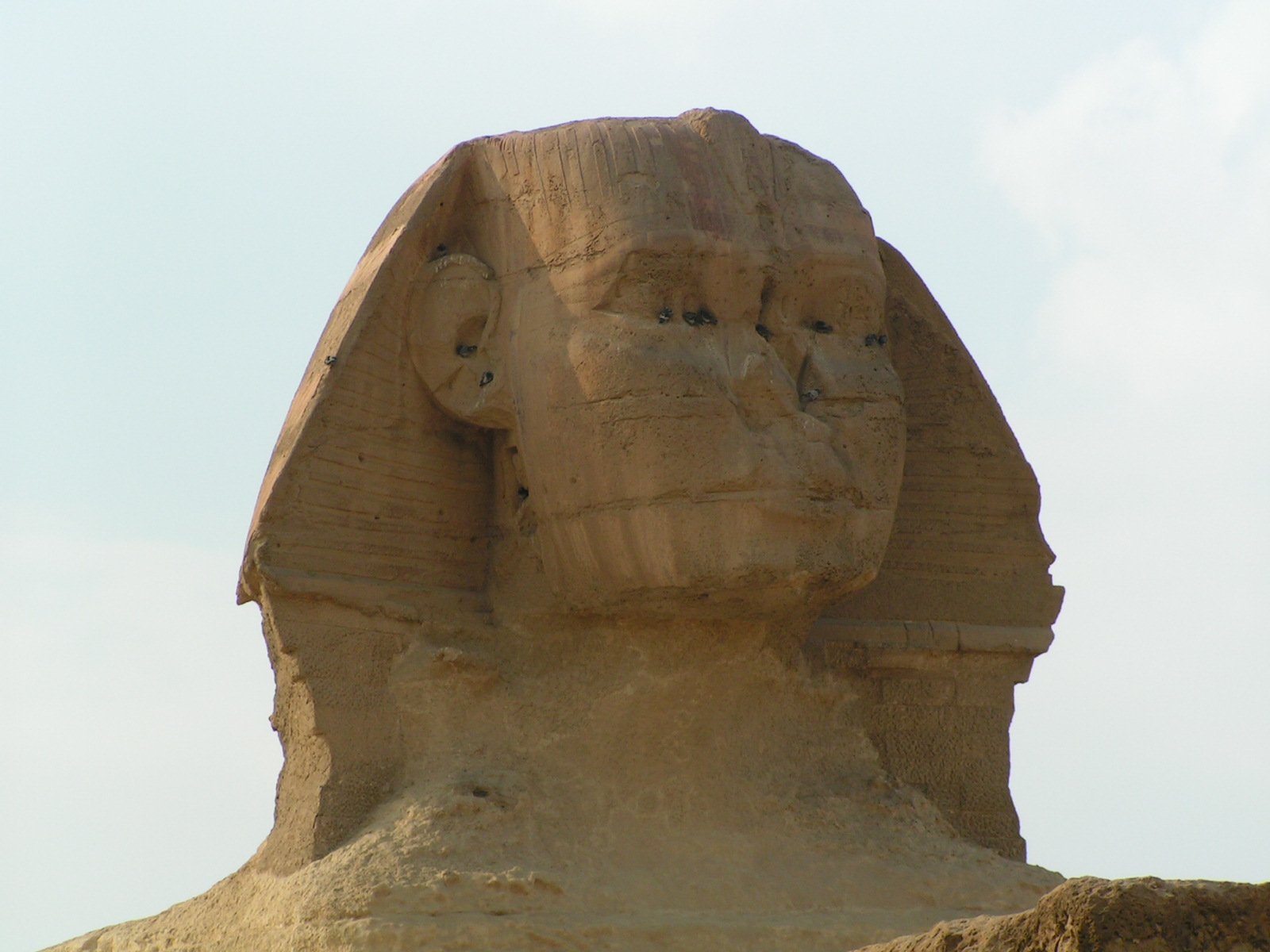 a large stone head of an egyptian god at the entrance to the temple of hatsheps