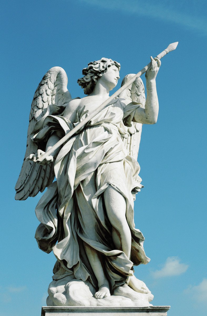 an angel statue is on top of a pillar